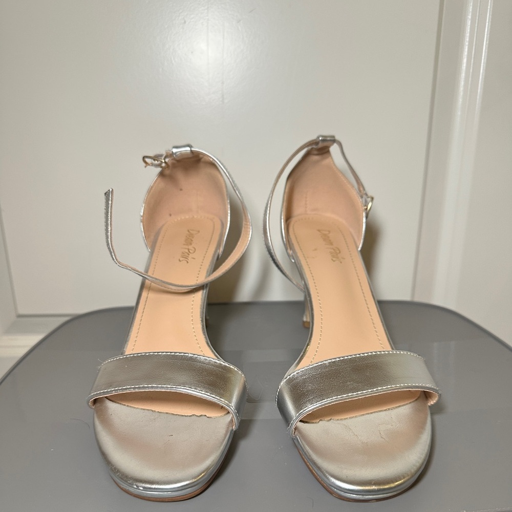 Silver 2 inch heel, size 9, worn, but still in good condition.